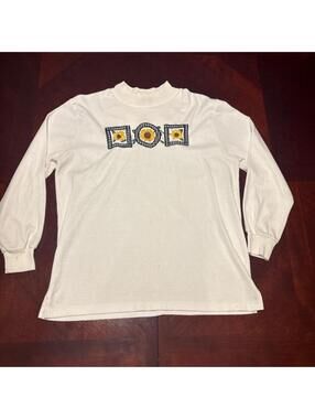 Cream long sleeve shirt with three sunflower graphics in checkered frames